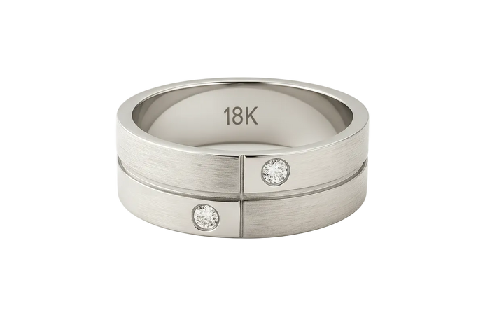 Gold ring with diamonds and '18K' marking on a white background